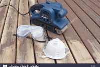 Belt Sander On Partially Sanded Wooden Decking During Renovation for proportions 1300 X 956