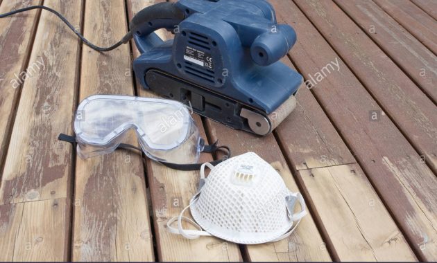 Belt Sander On Partially Sanded Wooden Decking During Renovation for proportions 1300 X 956