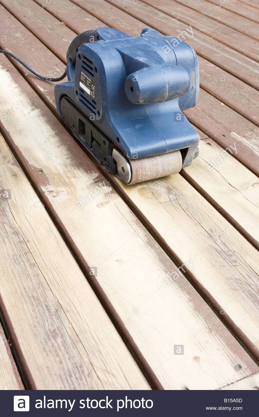 Belt Sander On Partially Sanded Wooden Decking During Renovation throughout sizing 866 X 1390