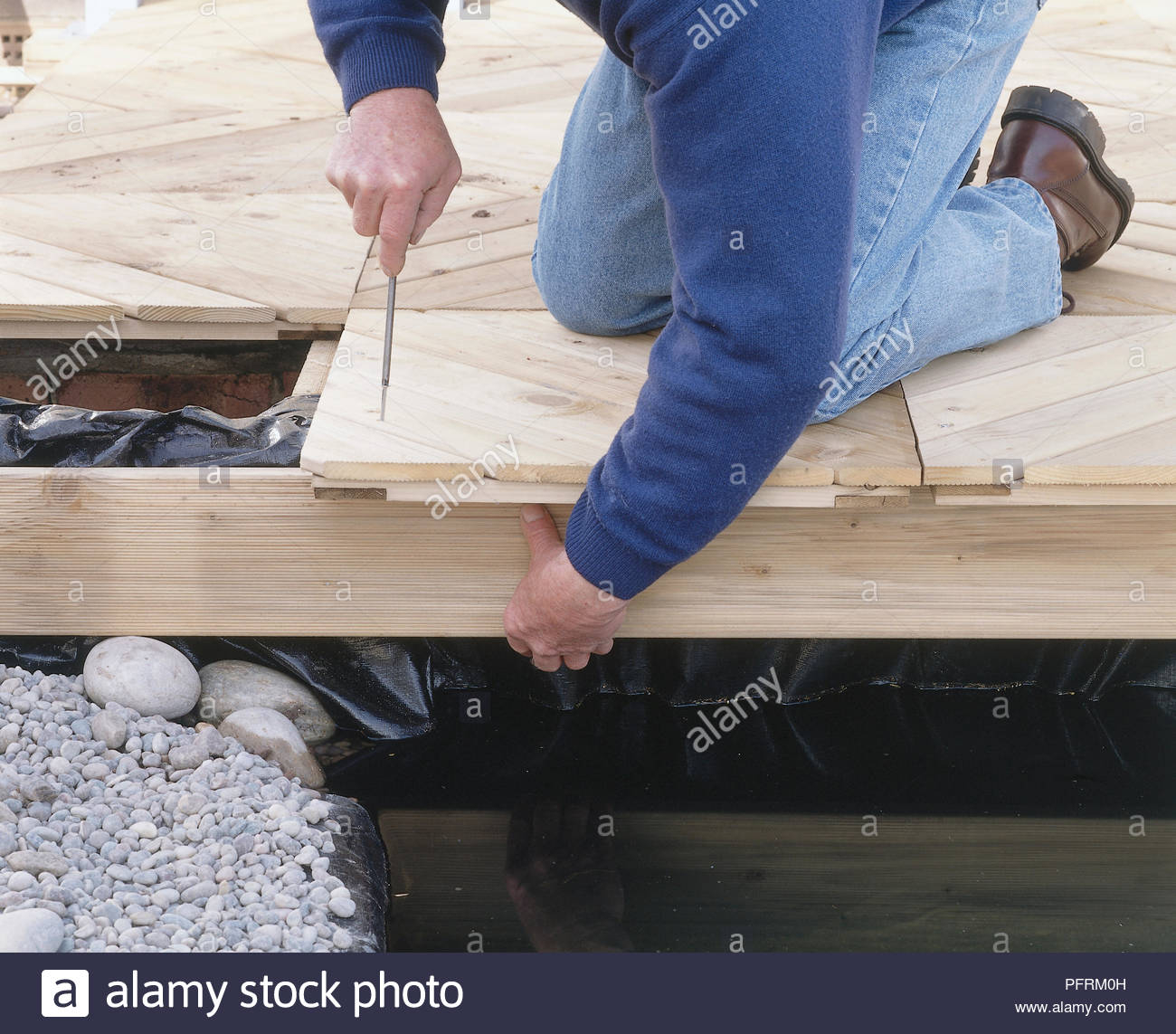 Laying Timber Decking At Side Of A Pond Screwing On A Timber Fascia inside size 1300 X 1143