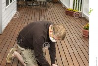 Mature Man Working On Natural Cedar Deck Stock Image Image Of in sizing 948 X 1300