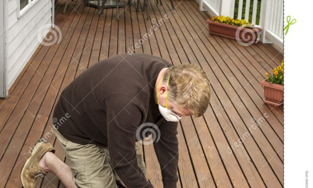 Mature Man Working On Natural Cedar Deck Stock Image Image Of in sizing 948 X 1300