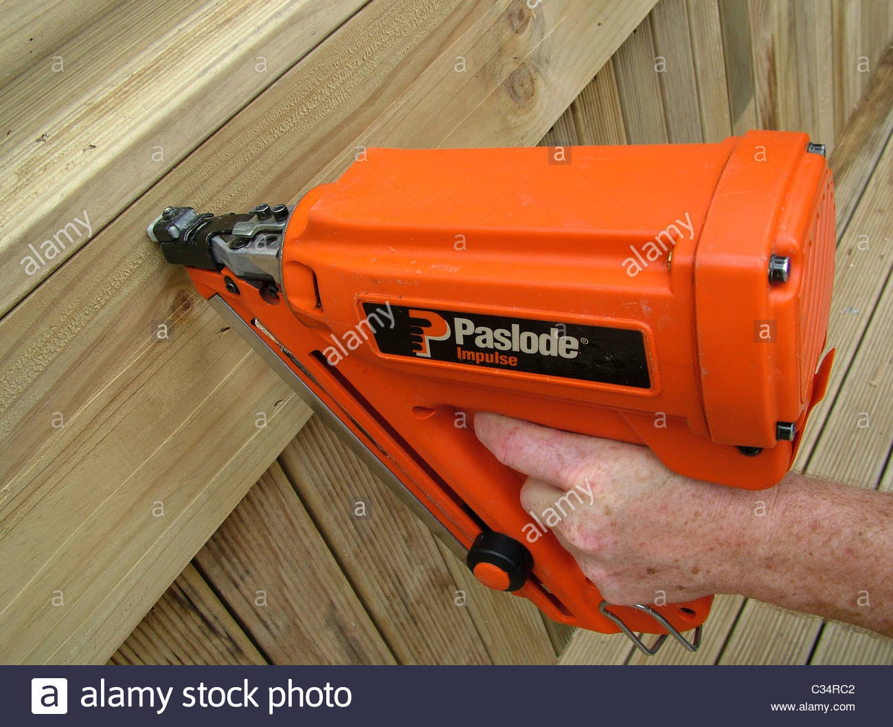 Nailing Timber Side Decking With An Orange Paslode Nail Gun Stock with regard to proportions 1300 X 1058