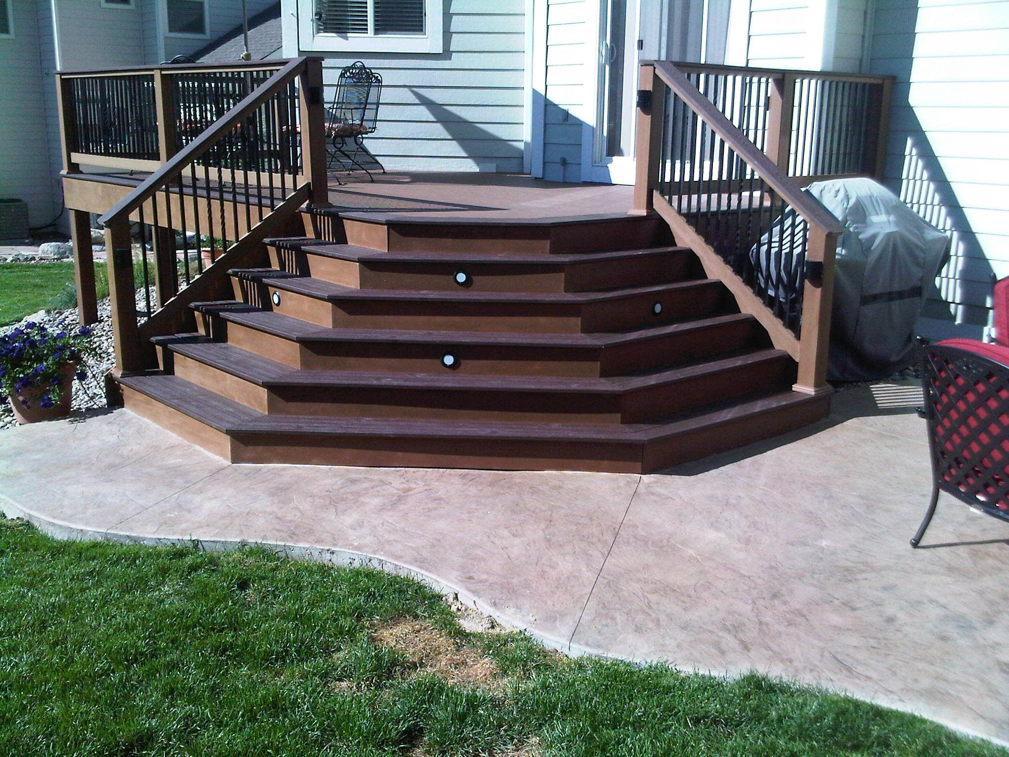 Splayed Trex Composite Deck Stairs Onto Stamped Concrete Patio with dimensions 2048 X 1536