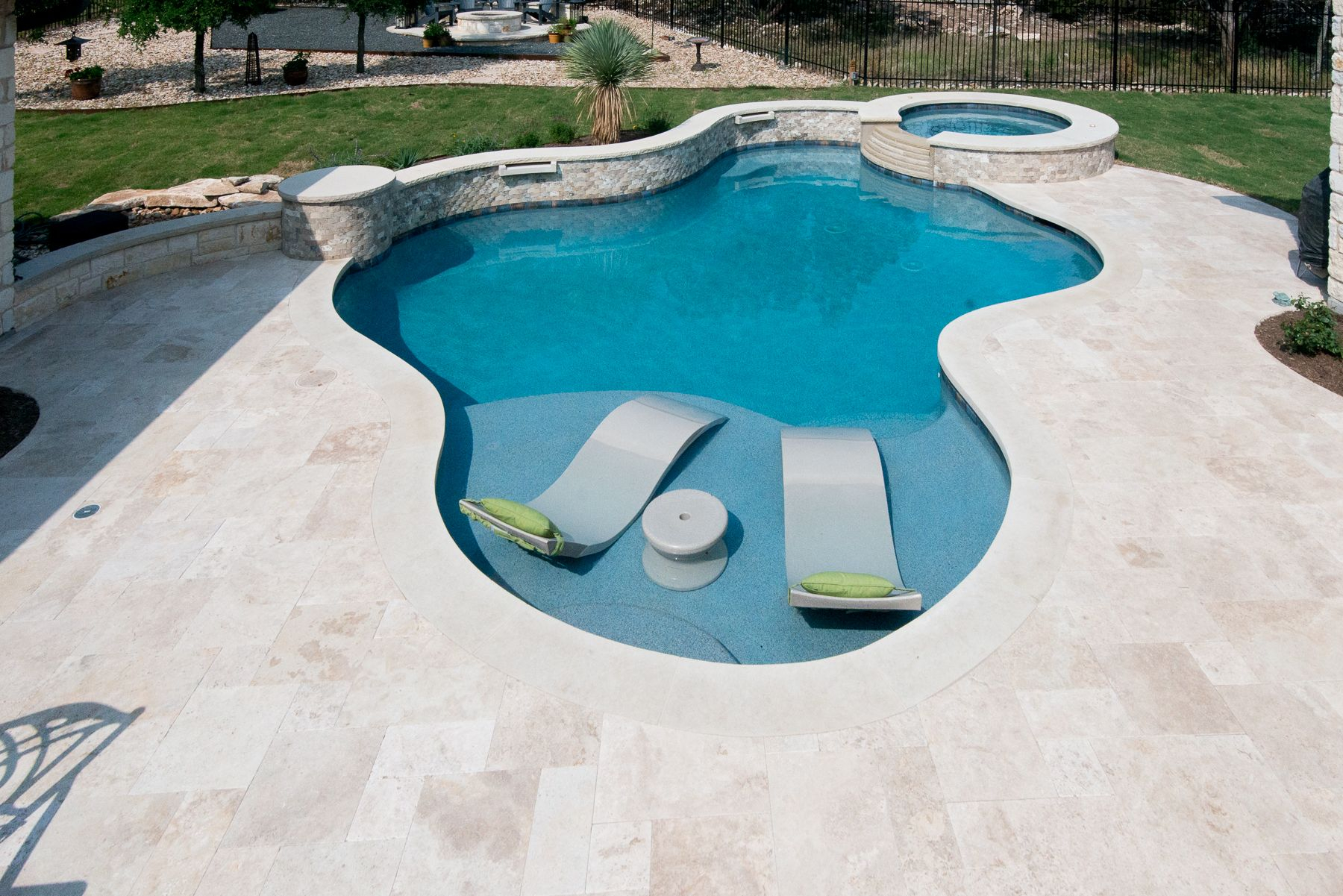 Travertine Deck With Lueder Coping Surrounding A Freeform Pool with regard to sizing 1800 X 1201