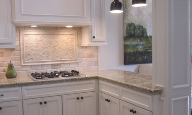 Kitchen With Off White Cabinets Stone Backsplash And Bronze within proportions 925 X 1210